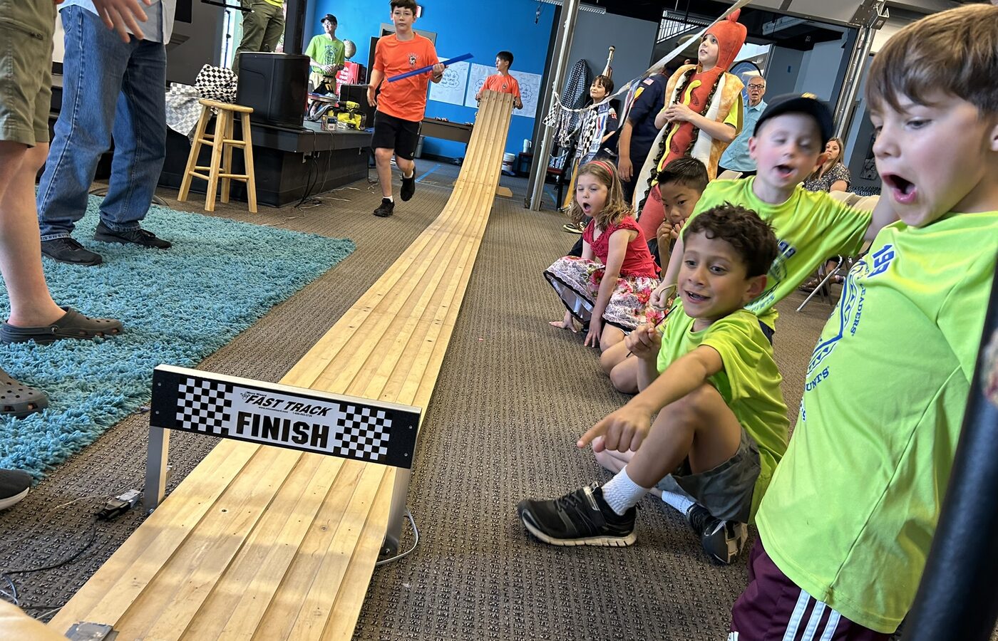 Pack 199 scouts and families at the Pinewood Derby track.